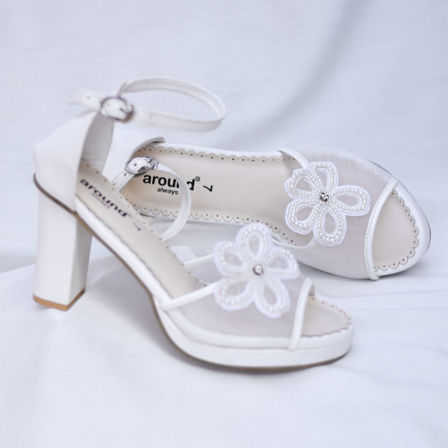 Stylish white wedding sandals with 3D flowers