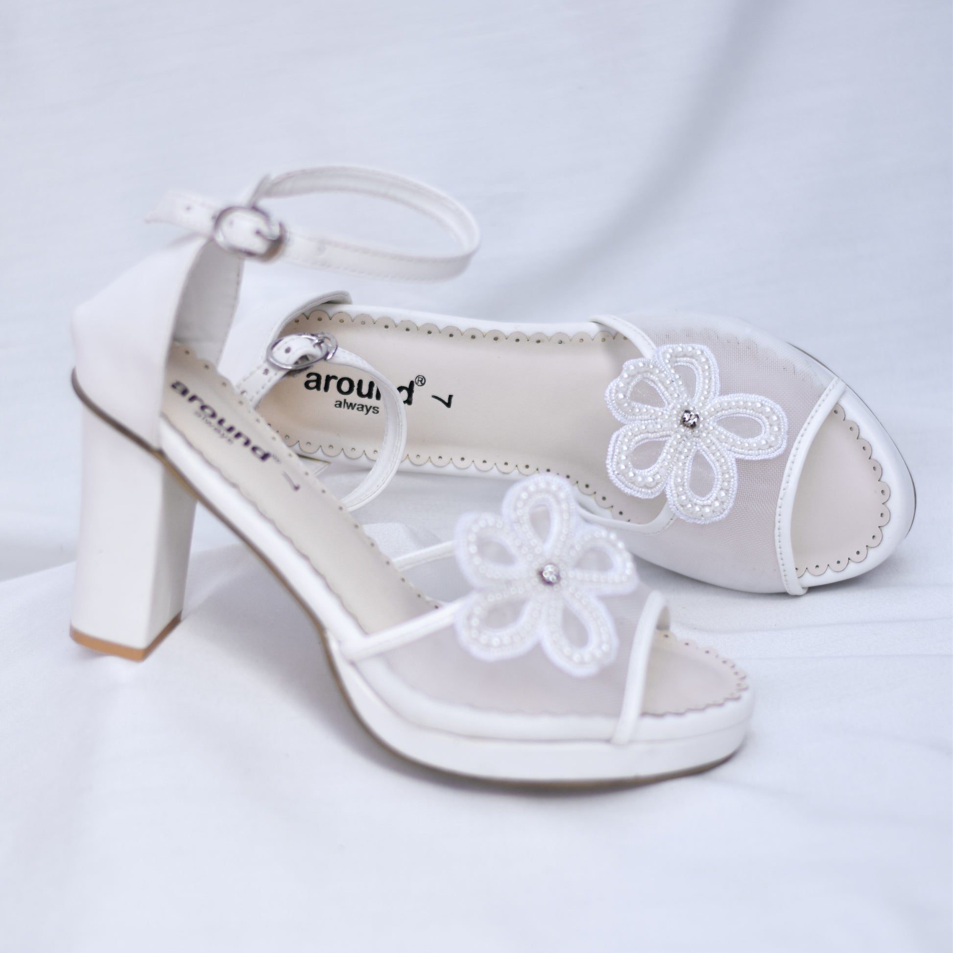 Stylish white wedding sandals with 3D flowers