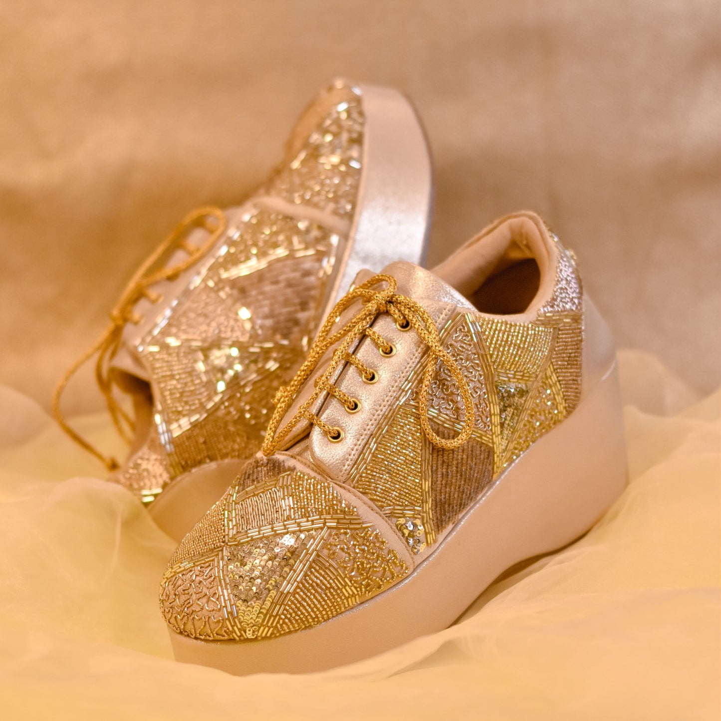 Stylish embroidered golden sneakers with heels