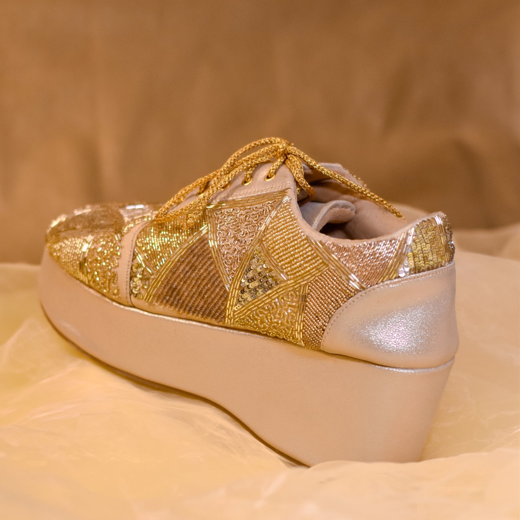 Shiny stylish golden sneaker wedges from India for the world