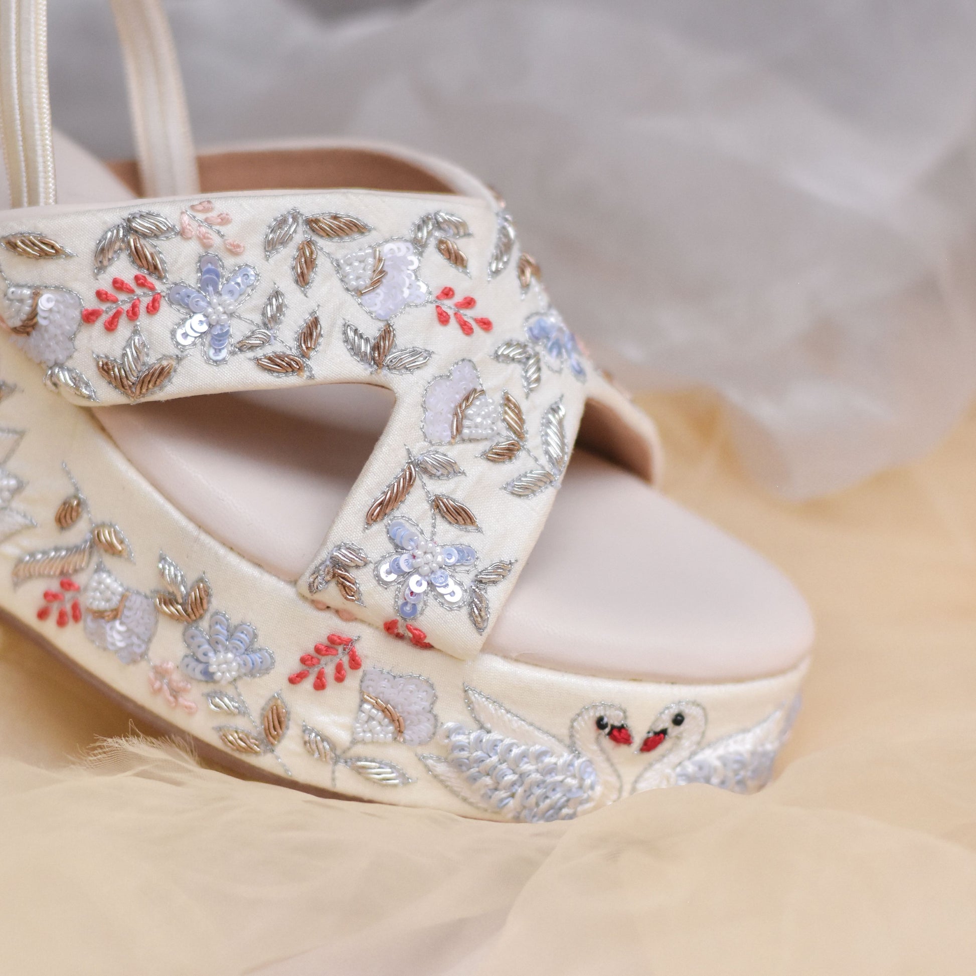 White bridal heels with golden and silver hand work