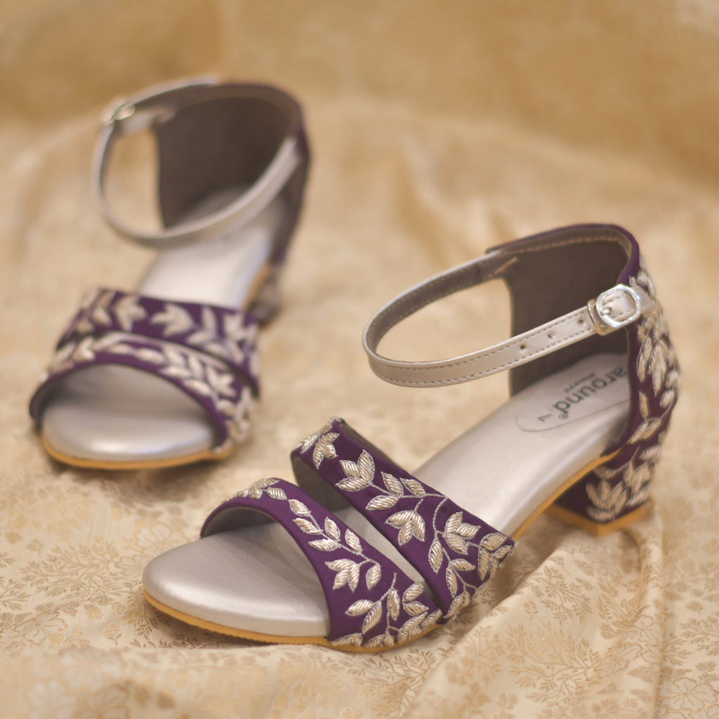 Premium Photo | A pair of sandals with purple and gold beads and a gold  design.